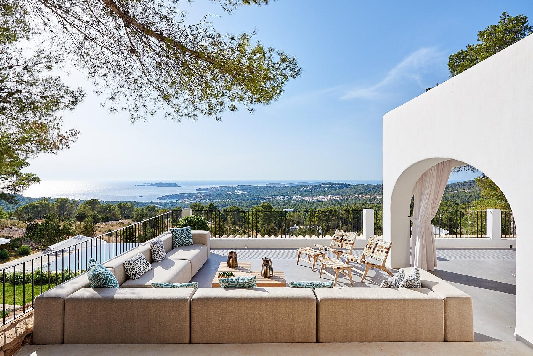 Villa terrace with white archway overlooking the coast